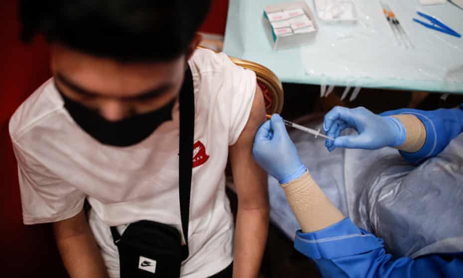 A teenager receives a dose of Pfizer COVID-19 vaccine