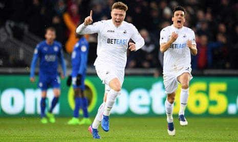 Swansea City’s Alfie Mawson celebrates scoring the opening goal against Leicester City, with Jack Cork running to congratulate him.