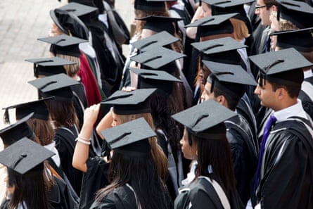 Students in graduation gowns and mortar board hats