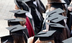 Graduates wearing mortar boards wait to be photographed after a degree ceremony