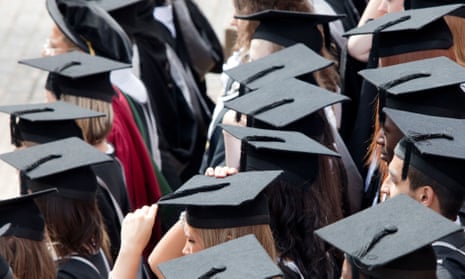University graduates wearing mortar boards and gowns stand in lines