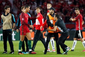 Ronaldo lets a fan approach him and take a selfie at the end of the game.