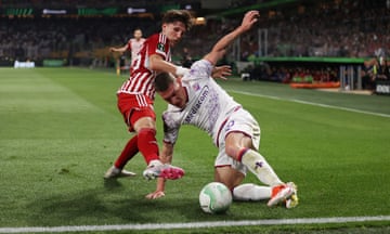 Panagiotis Retsos of Olympiacos (left) and Andrea Belotti of Fiorentina battle for possession by the goall-line during the Europa Conference League.