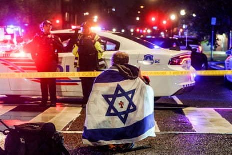 A man with an Israeli flag draped on his shoulders near the scene where two people were shot and killed near the Capital Jewish Museum in Washington DC, USA.