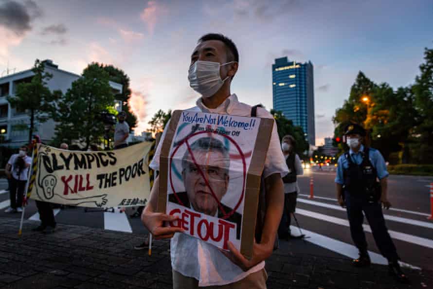 A protester holds a banner with a photo of Thomas Bach during a rally against the Games earlier this week.