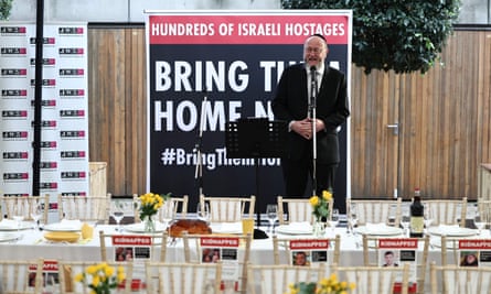 Sir Ephraim Mirvis speaking from a podium in front of a sign