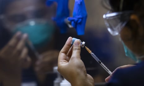 A healthcare worker prepares a Pfizer vaccine