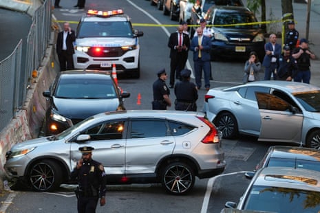 Cars and people at scene of shooting