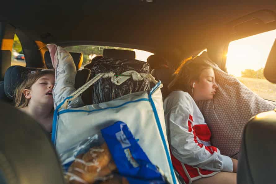Two sisters asleep on roadtripGettyImages-1015400126