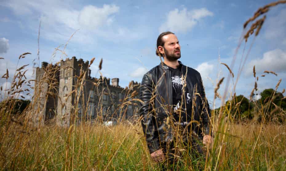 Lord Randal Plunkett in long grass with castle in background