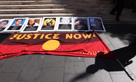 An Aboriginal flag with “Justice Now” written on it lies on the pavement before a protest march on 10 April 2021 in Sydney, Australia. 