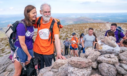 Nick Gardner is hugged by his daughter Sally McKenzie after reaching the top of Cairn Gorm 