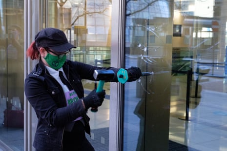 Handout photo issued by Extinction Rebellion of their protest at Barclays in Canary Wharf, London, where they used hammers and chisels to break windows.