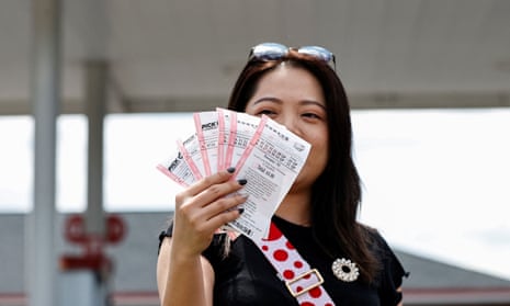 Customer Angelina Weng shows her purchased lottery tickets in Des Plaines, Illinois.