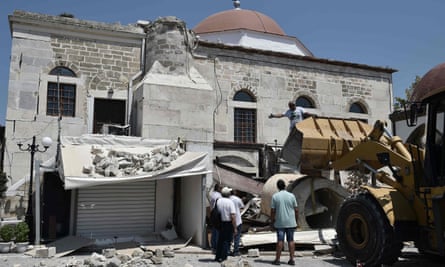 Workers remove rubble from a quake-damaged mosque in Kos