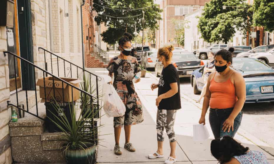 Baltimore HeatTehma Smith Wilson of The Door, a resiliancy hub in Baltimore distributes food and water to residents on June 24, 2021.