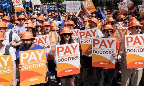 Junior doctors with placards rally outside Downing Street during strike action over pay