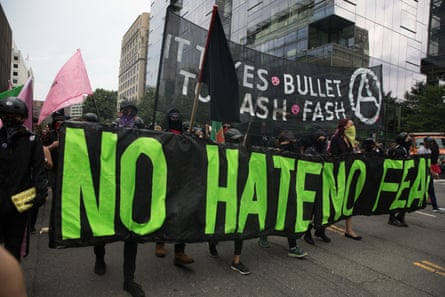Antifa, opponents of white nationalist, holds banners during a rally, marking the one year anniversary of the 2017 Charlottesville 'Unite the Right' protests.