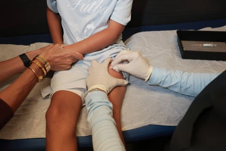 a young boy getting a shot