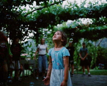 Zorya, 6, popping bubbles outdoors