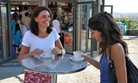 Two women drinking coffee in Italy