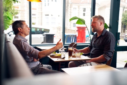 Miles and Celestino sit facing each other across the table at The Saigon Kitchen in Bristol.