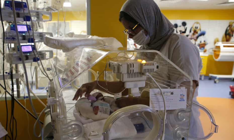 A Moroccan nurse takes care of one of the nine babies protected in an incubator.