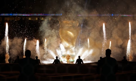Workers carrying a giant Argentina flag during a fireworks display featuring a huge inflatable World Cup just before the quarter-final between the Netherlands and Argentina