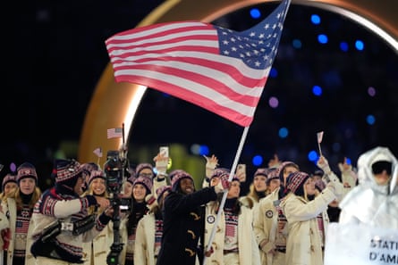 Erin Jackson waves the American flag during the opening ceremony at San Siro stadium.