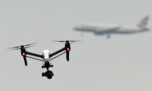 A drone flying in Hanworth Park in west London as a British Airways plane prepares to land at Heathrow airport.