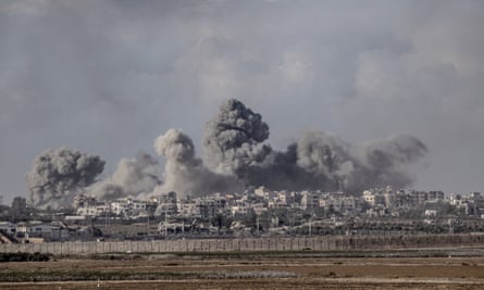 Smoke rising from the Shuja’iyya district of Gaza after Israeli strikes on 9 December.