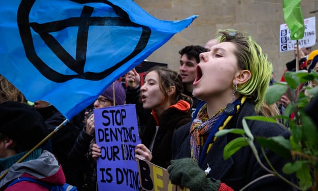 Environmental protesters from the Extinction Rebellion group chant during a demonstration outside BBC Broadcasting House in central London