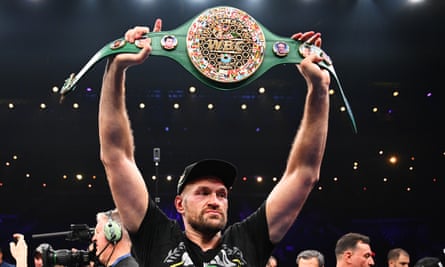 Fury holds up his WBC World Heavyweight belt after his victory.