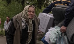 An elderly woman walking as civilians in Vovchansk and surrounding regions are evacuated