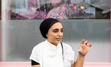 Kauser Patel looks off camera as she raises a hand while speaking