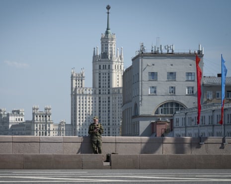 A man in a military uniform checks his mobile phone in Moscow, Russia.