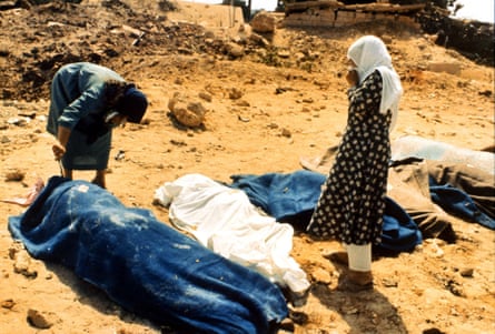 Two women inspect the bodies of people killed in the Sabra and Shatila massacre in 1982.