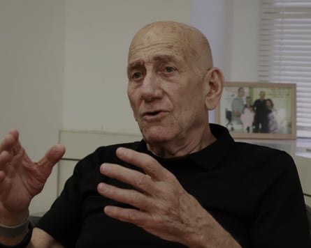 Ehud Olmert gesticulates with his hands during an interview.