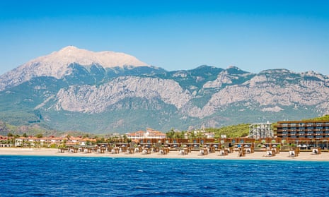 Hotel on the beach against the backdrop of the mountain Olympus (Tahtali Dagi), Turkey.