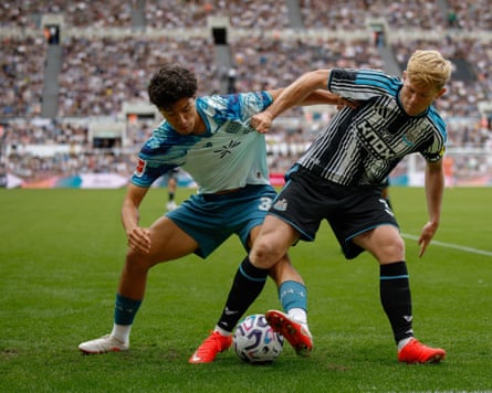 The Newcastle left-back Lewis Hall (right) tussles for the ball with the Bayer Leverkusen winger Ibrahim Maza (left) during a home pre-season friendly.