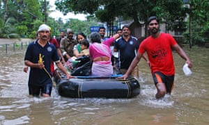 Volunteers and rescue personnel evacuate residents in a boat in Kozhikode, in the Indian state of Kerala.