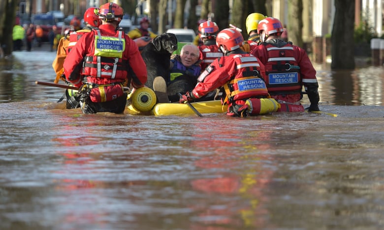 A rescue team helps to evacuate people from their homes after Storm Desmond caused flooding.