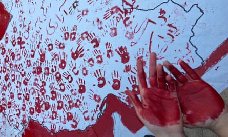 An Iranian student after daubing a map of Iran on a wall with handprints, allegedly at a sit-in protest at the Art University of Isfahan over the weekend.