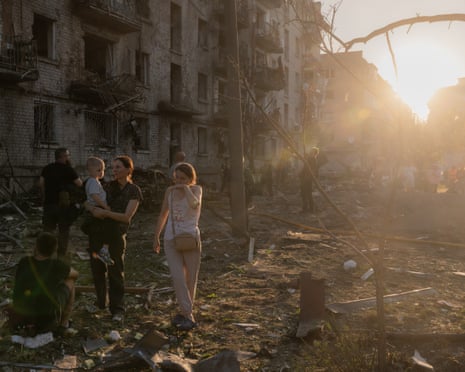 Residents gather at the site of a residential building damaged following a Russian air attack on the Ukrainian capital of Kyiv.