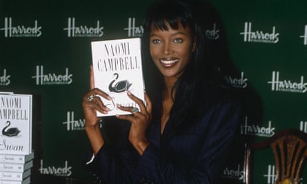 Naomi Campbell holds up her book Swan for the cameras