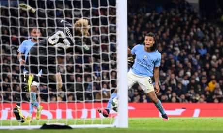 Nathan Aké watches his header go past Liverpool goalkeeper Caoimhín Kelleher