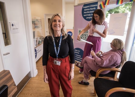Lecia Fraser looks at the camera. Two women are in the background talking