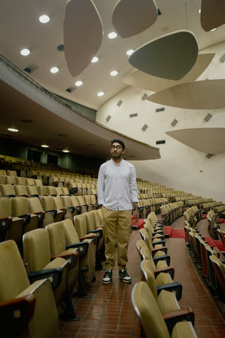 Jesús Piñero stands by empty sears in a lecture theatre at the Central University of Venezuela.