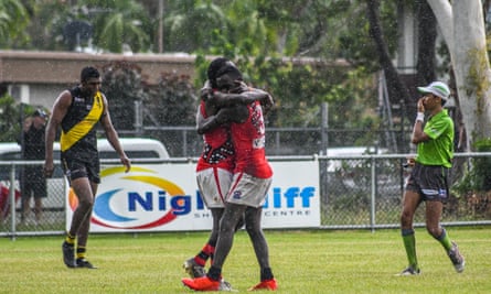 Simon Munkara kicks a goal and then embraces his brother, Dion, during the third quarter of the Bombers clash with Nightcliff