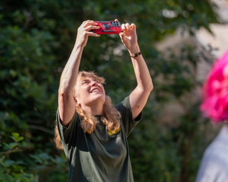 A person holds up their phone to take a photo